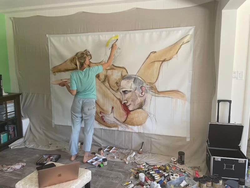 Marina Orlova painting large figurative mural in studio