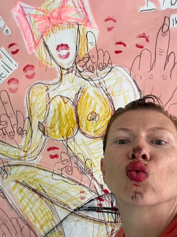 Marina Orlova posing with suggestive wall drawing in studio