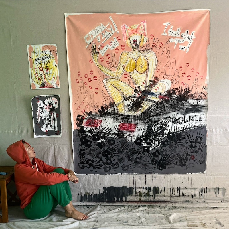 Marina Orlova viewing large expressive figurative street art installation