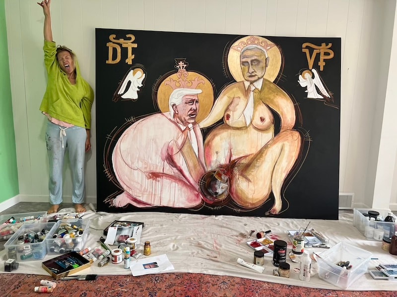 Marina Orlova beside large-scale political figurative painting in studio