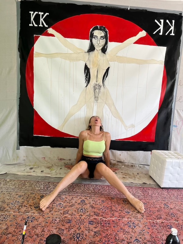 Marina Orlova posed in front of Vitruvian Woman canvas in progress