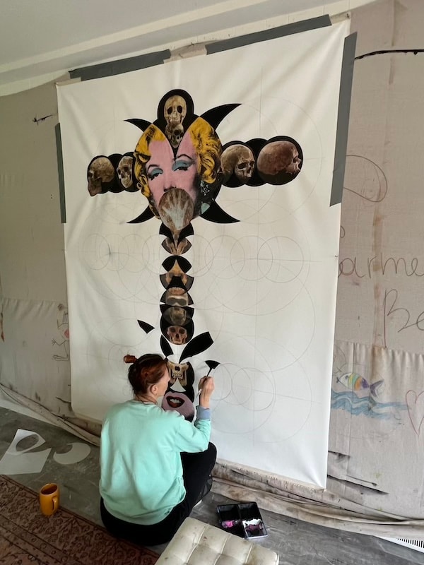Marina Orlova creating surreal collage artwork in studio