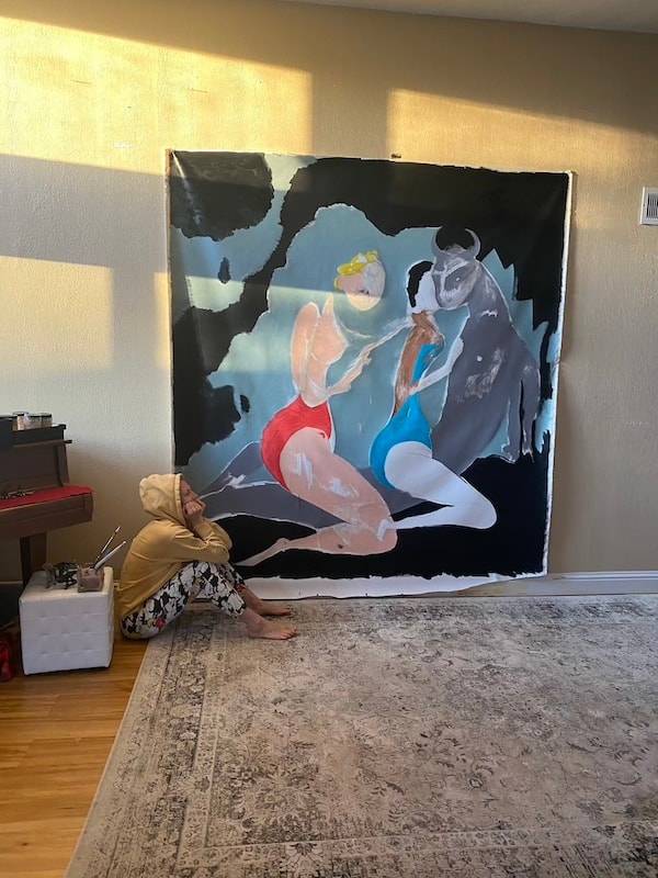 Marina Orlova painting large mural on studio wall