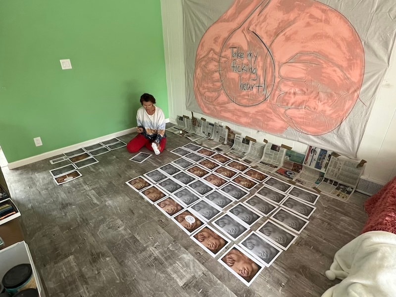 Marina Orlova arranging photographs on studio floor