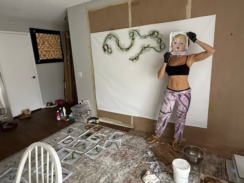 Marina Orlova with doll-head art installation in studio