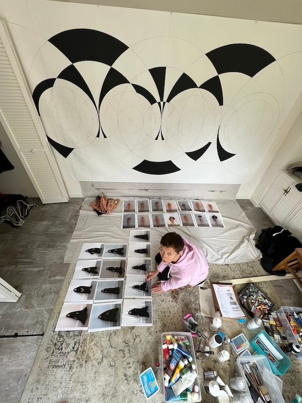 Marina Orlova working on moon phase ceiling mural in studio