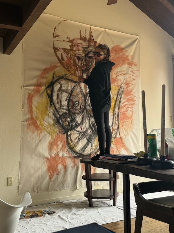 Marina Orlova painting large abstract canvas on studio wall